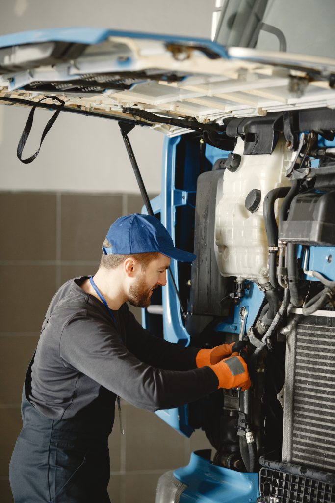 a person is working on the engine of a truck