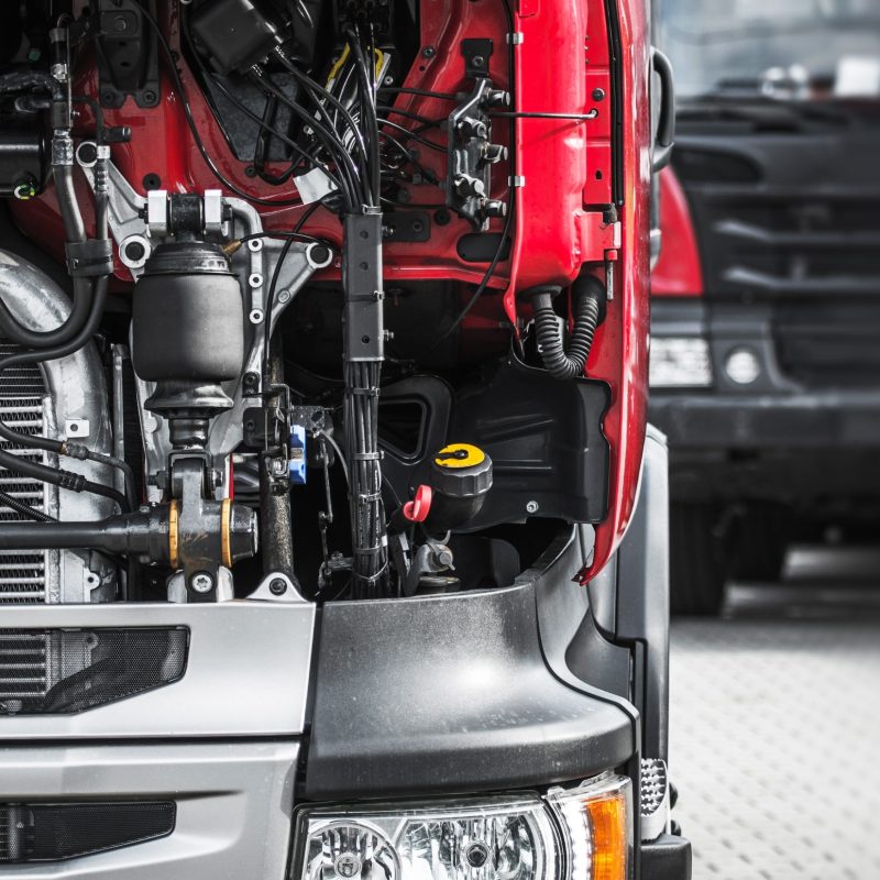 a close up of a truck engine with its hood open a close up of a truck engine with its hood open
